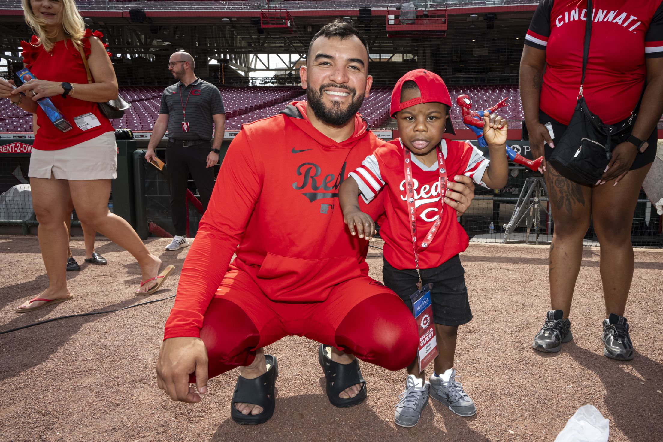 Jose Trevino is all smiles with a child from the Make-A-Wish Foundation at Great American Ball Park.