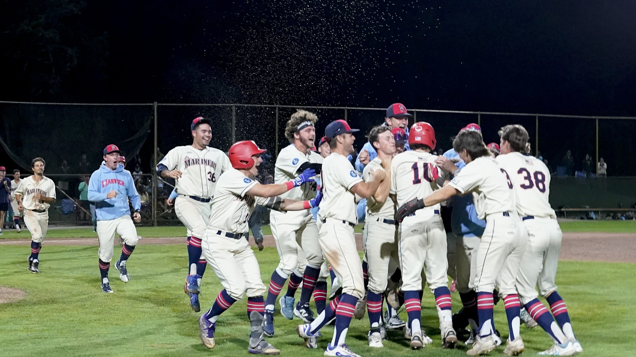 The Harwich Mariners surround Patrick Fultz after a game-winning sacrifice bunt.
