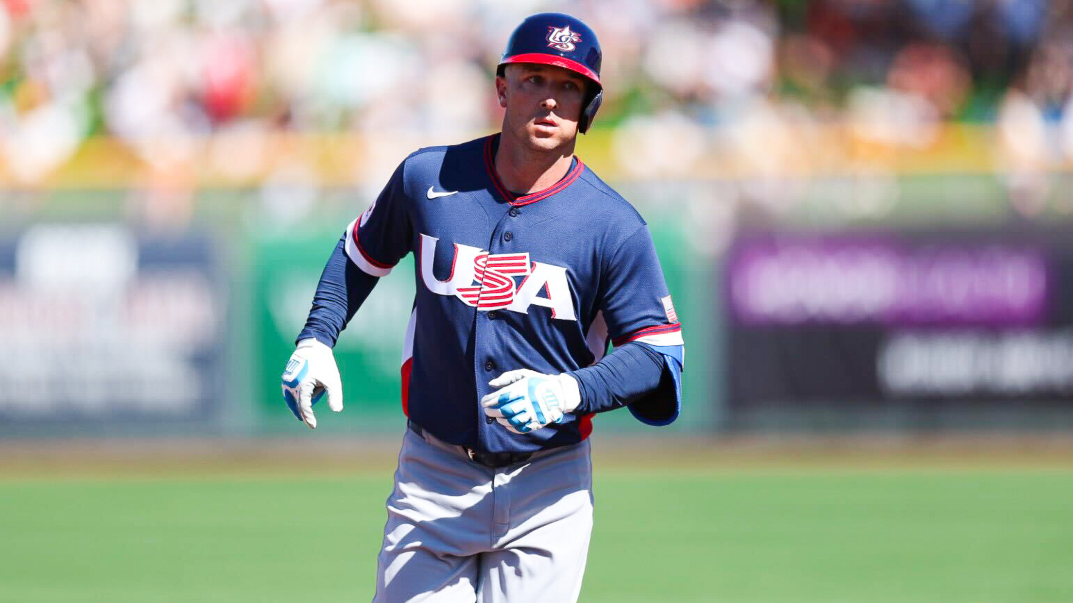 Baseball player in Team USA gear rounding the bases