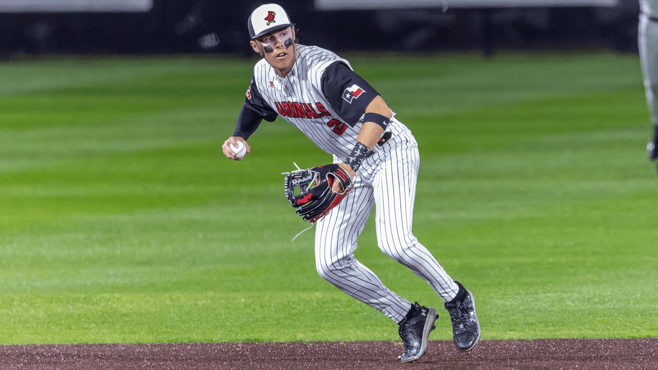 Fort Worth Christian shortstop Grady Emerson readies to throw a ball to first base