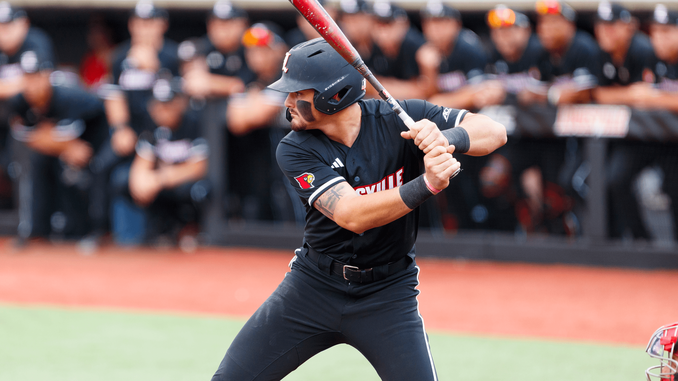 Louisville first baseman Tague Davis in his stance at home plate without batting gloves.