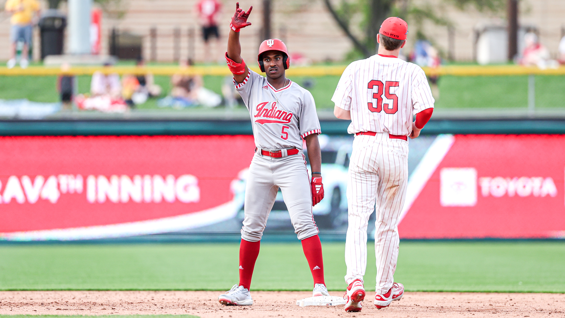 Indiana outfielder Devin Taylor signals back to the dugout after reaching second base.