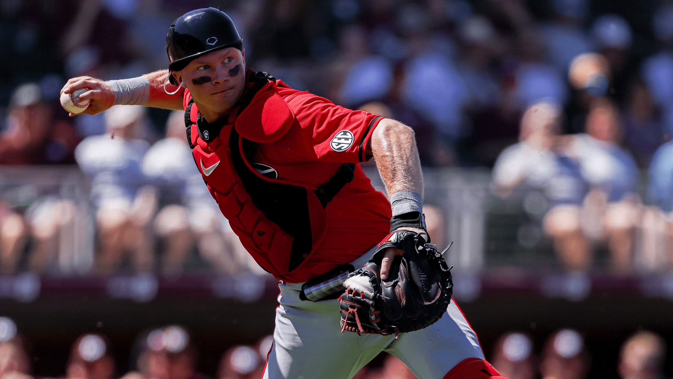 Georgia catcher Dylan Jackson makes a throw towards first base from in front of home plate.