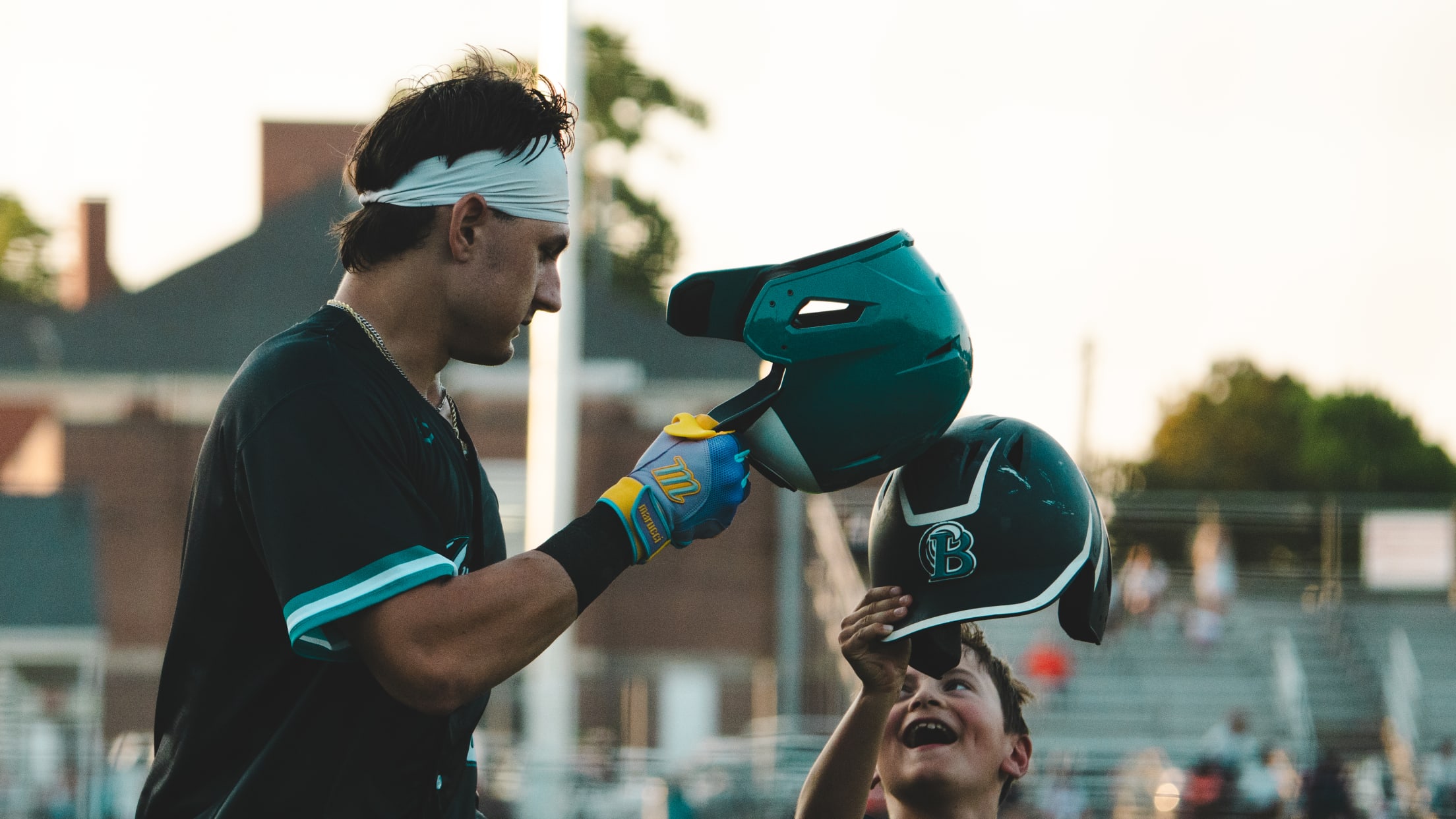 Eddie Yamin IV gives the batboy a helmet bump after sending one out of the park.