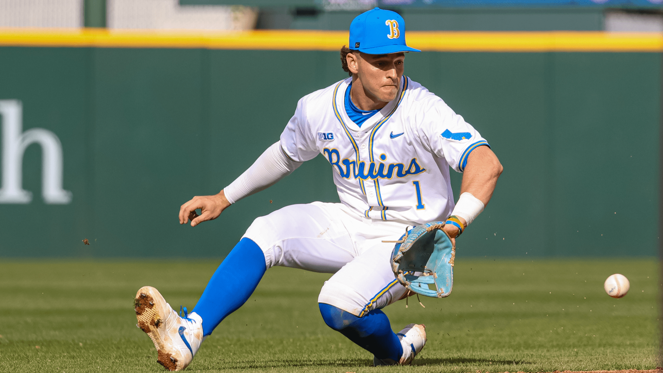 UCLA shortstop Roch Cholowsky fields a ball on the edge of the infield dirt.