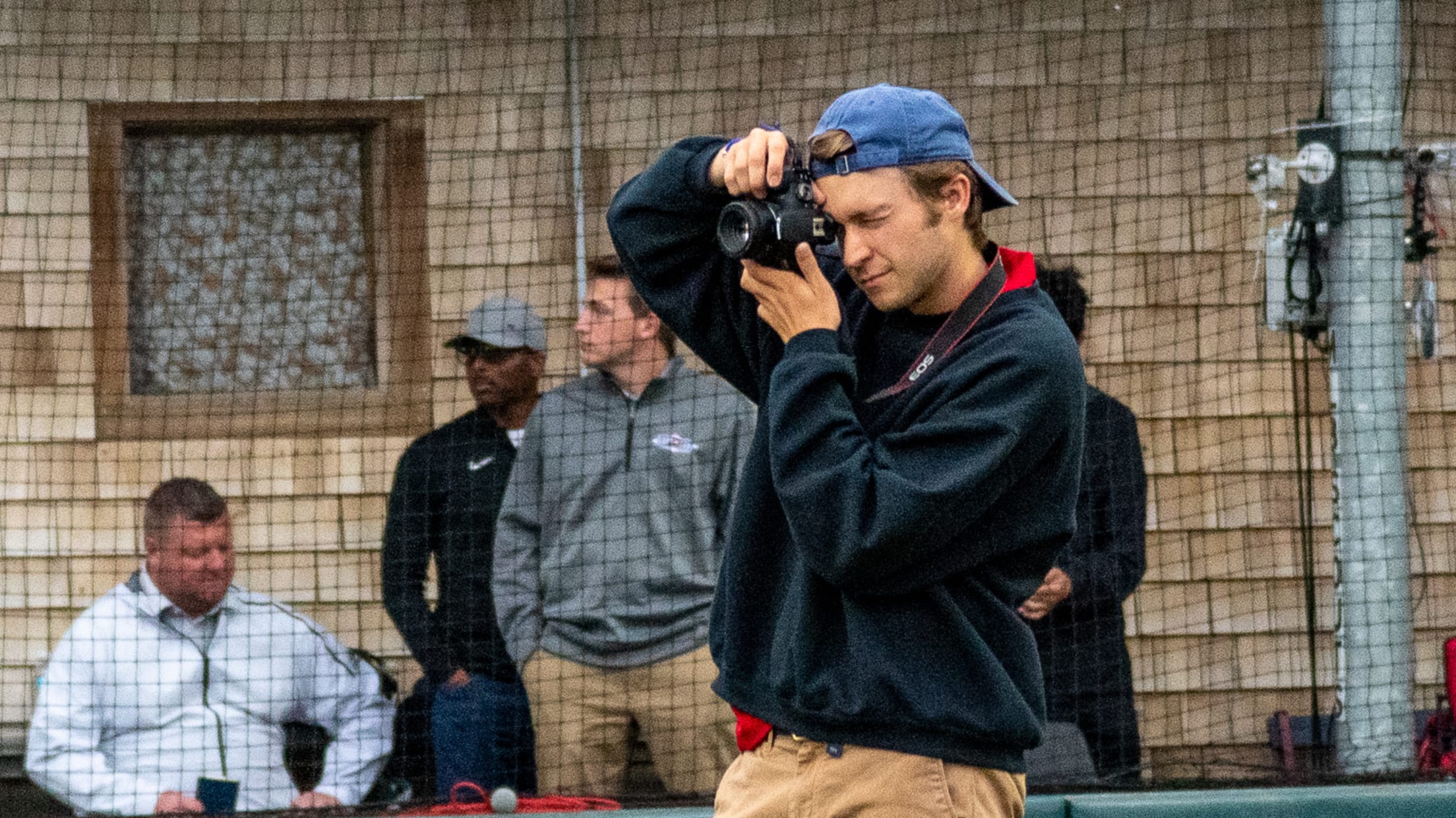 Firebirds intern takes a photo while in foul territory.