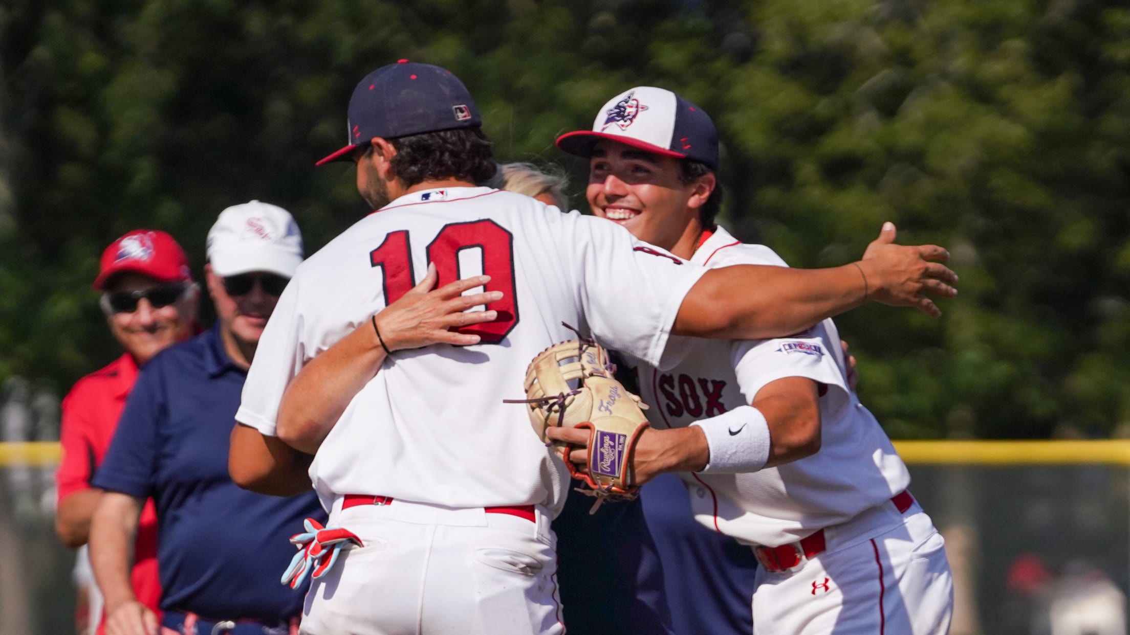 YD Red Sox players embrace during game.