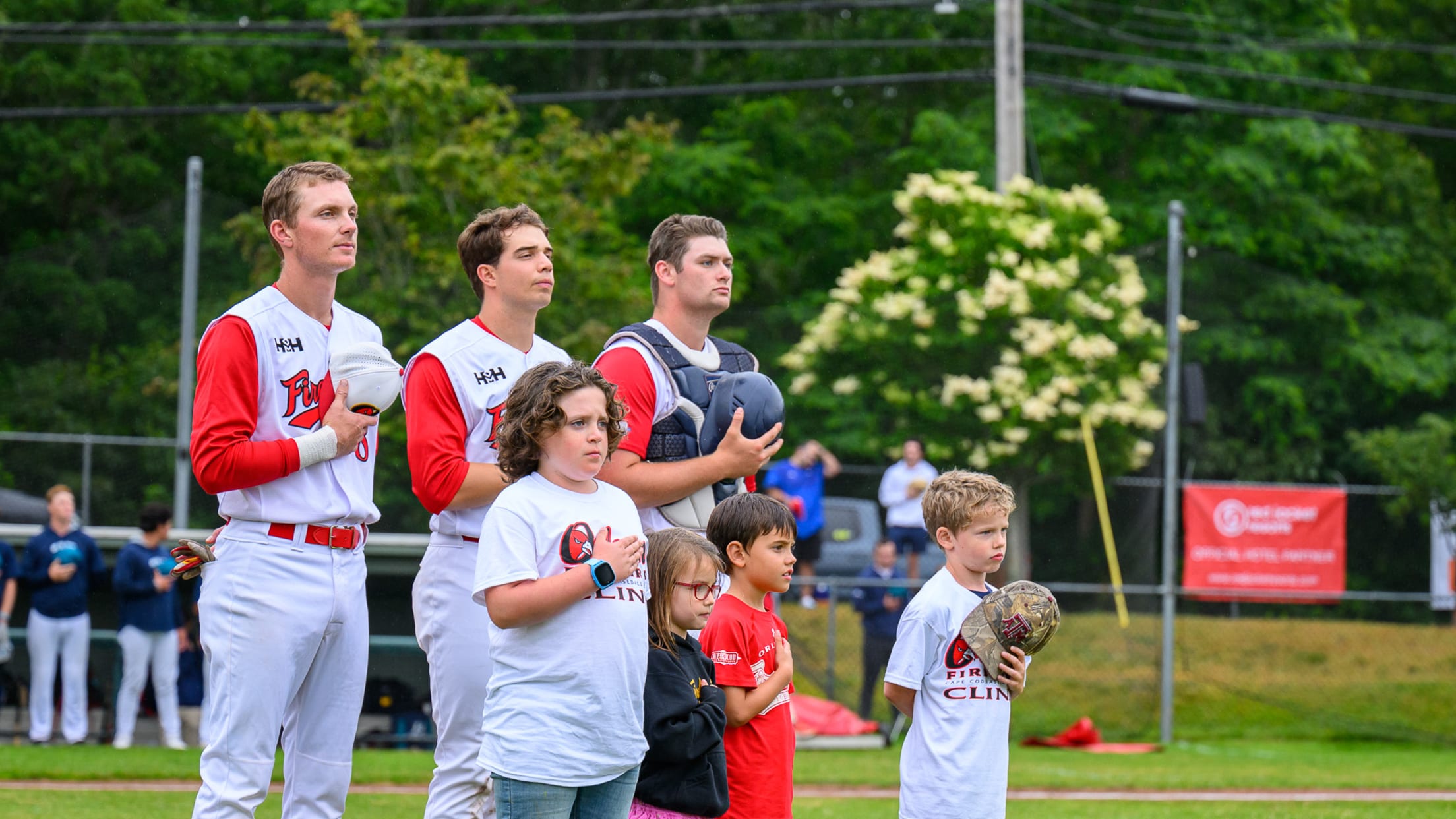 Children stand with the Firebirds during the national anthem.