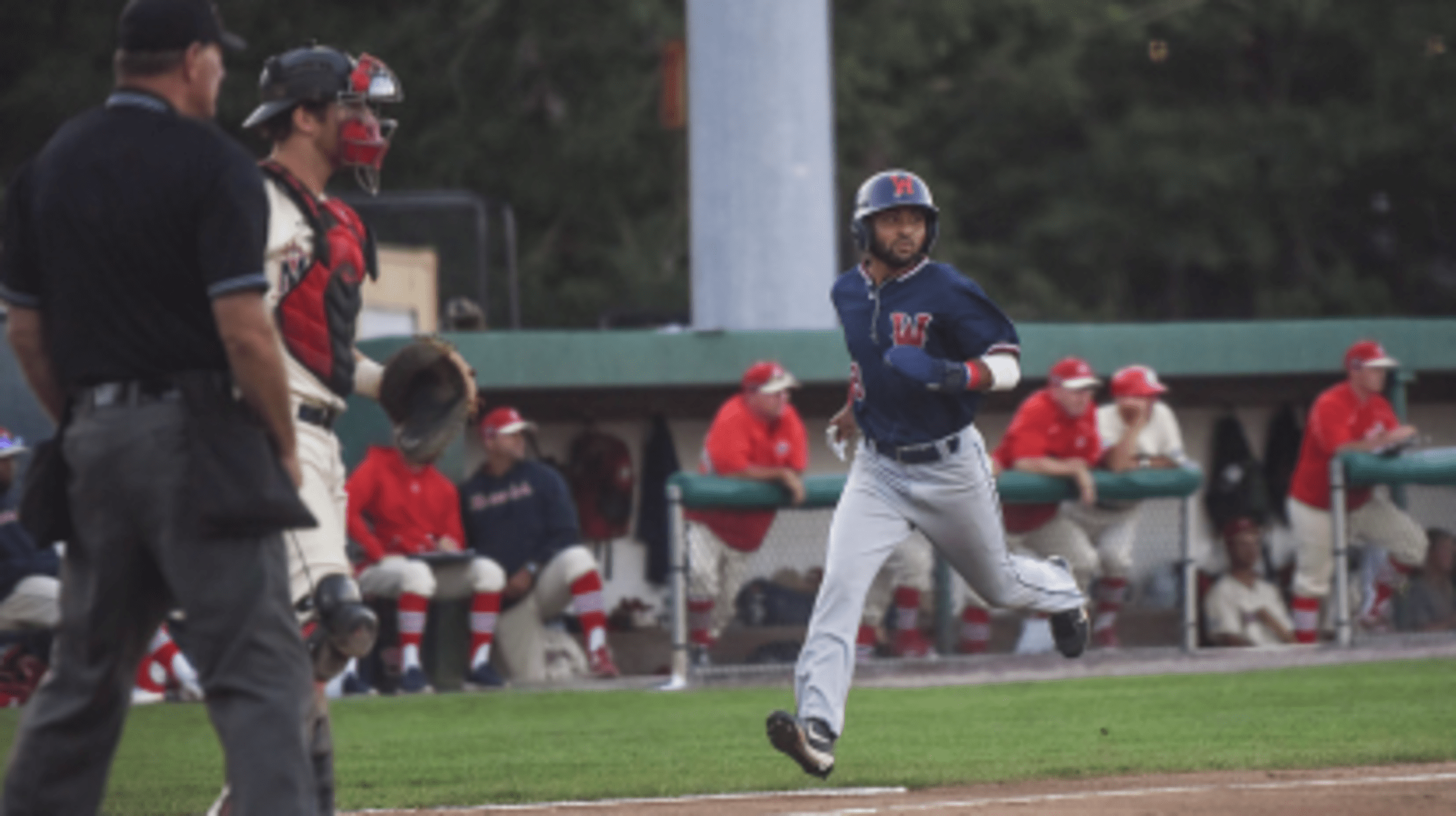 A Wareham Gateman player runs towards home plate from third with his eyes towards the first base line.