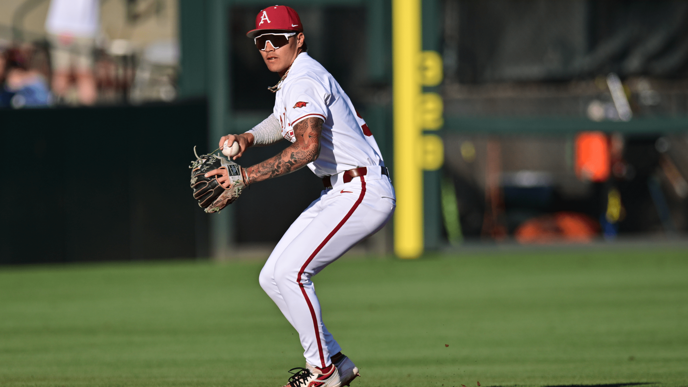 Arkansas shortstop Wehiwa Aloy prepares to throw a ball in the field.