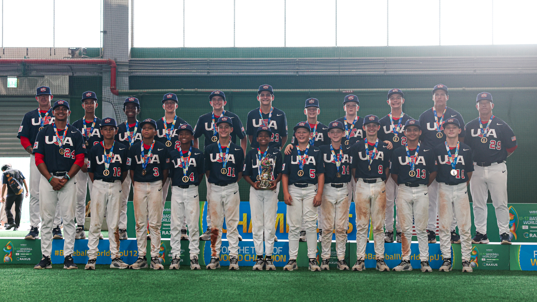 Two rows of baseball players with medals posing for a photo