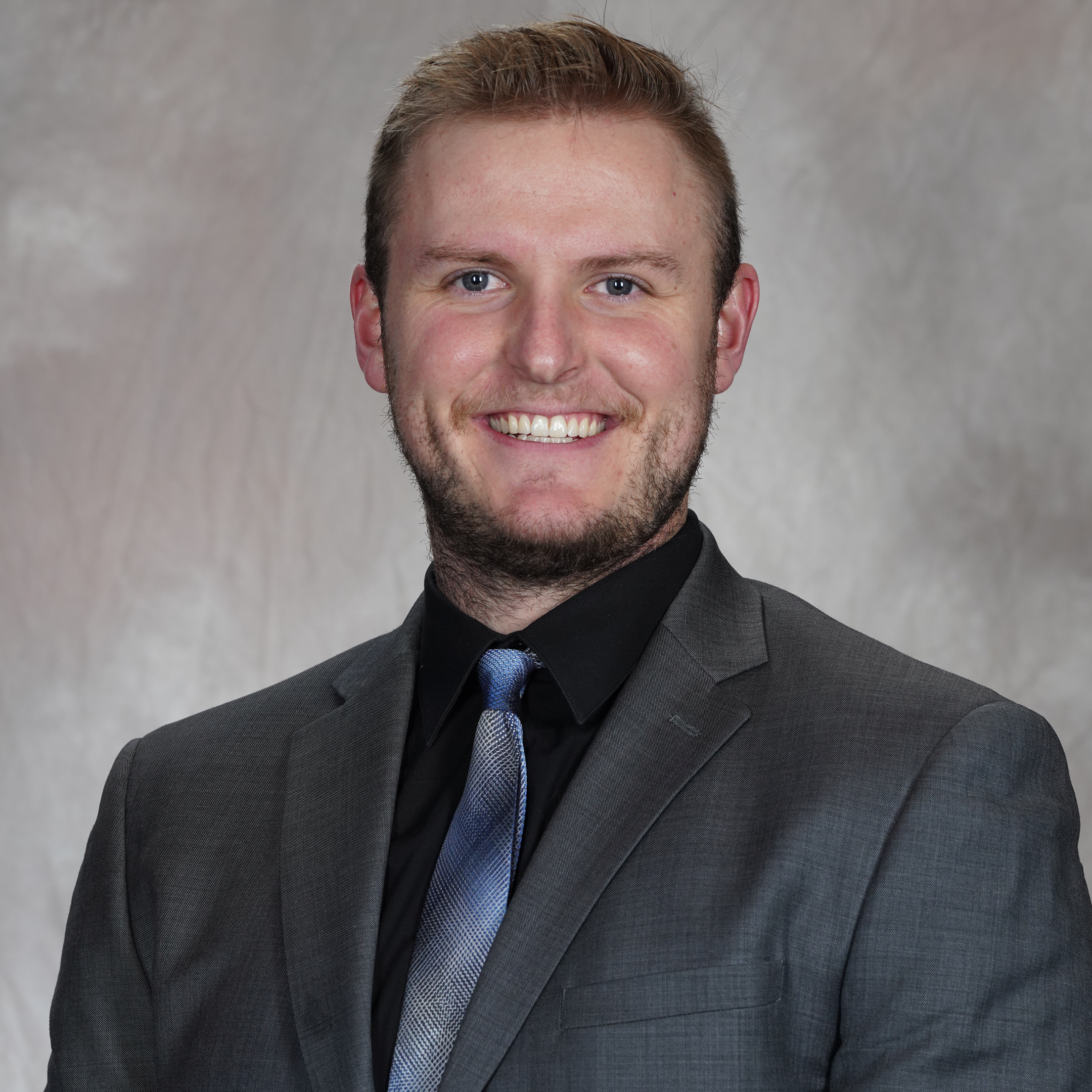 Danville general manager Konor Lathrop in a suit and tie.