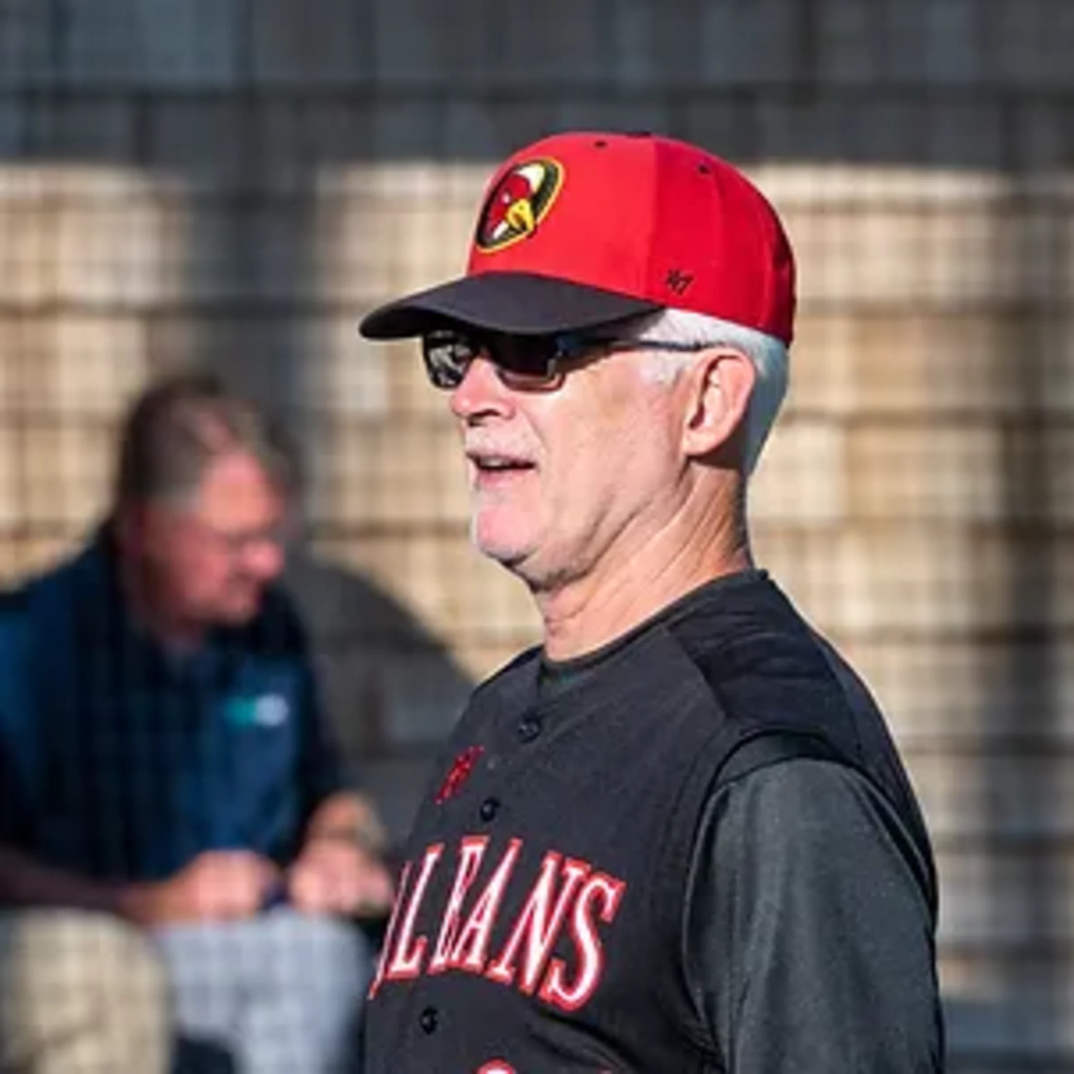 Orleans manager Kelly Nicholson stands in the third base coaching box.