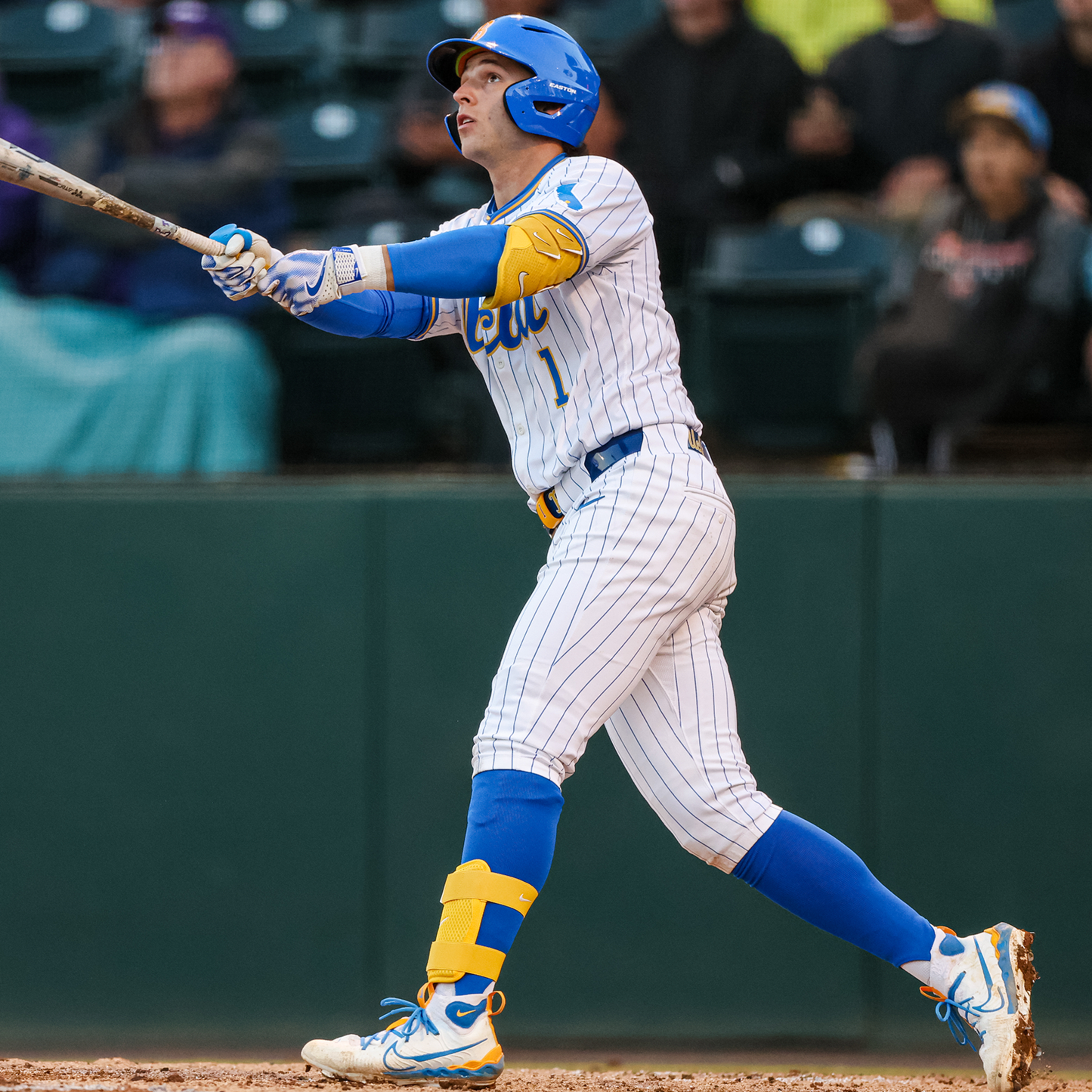 UCLA shortstop Roch Cholowsky holds his follow-through and watches the flight path of his batted ball.