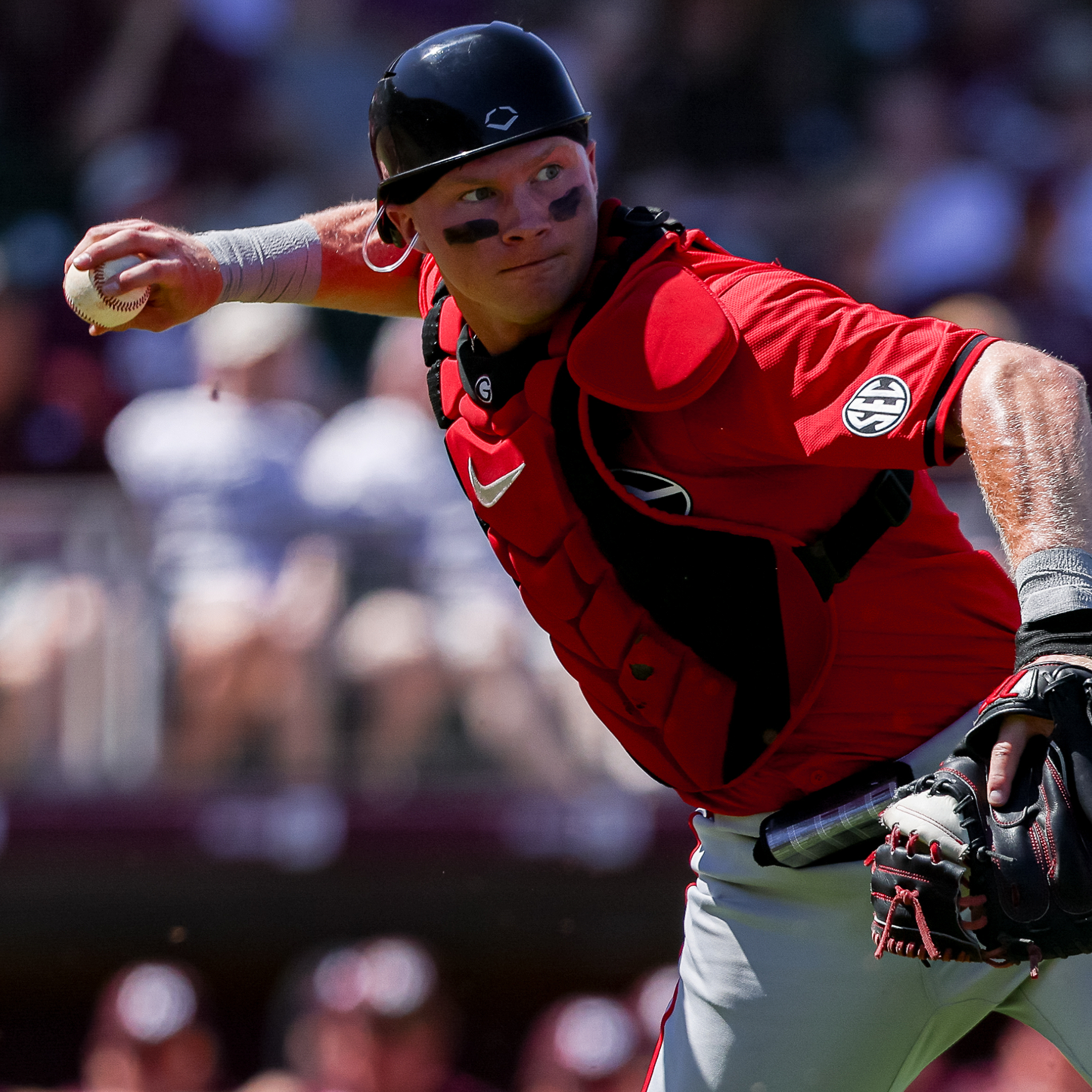 Georgia catcher Dylan Jackson makes a throw towards first base from in front of home plate.