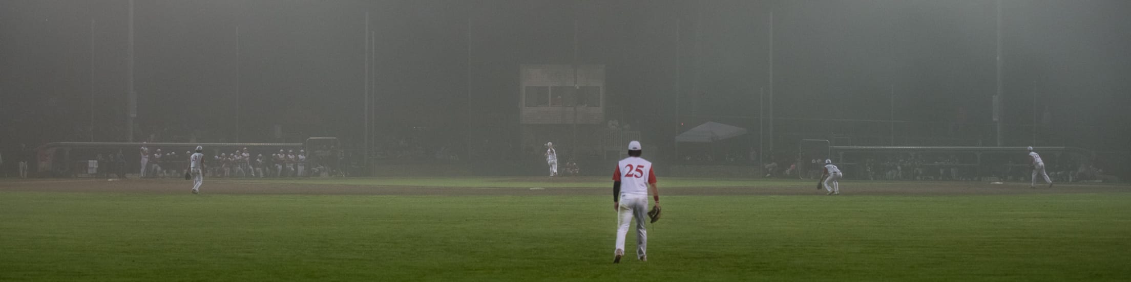 Eldredge Park during a game with the view in from beyond the outfield.