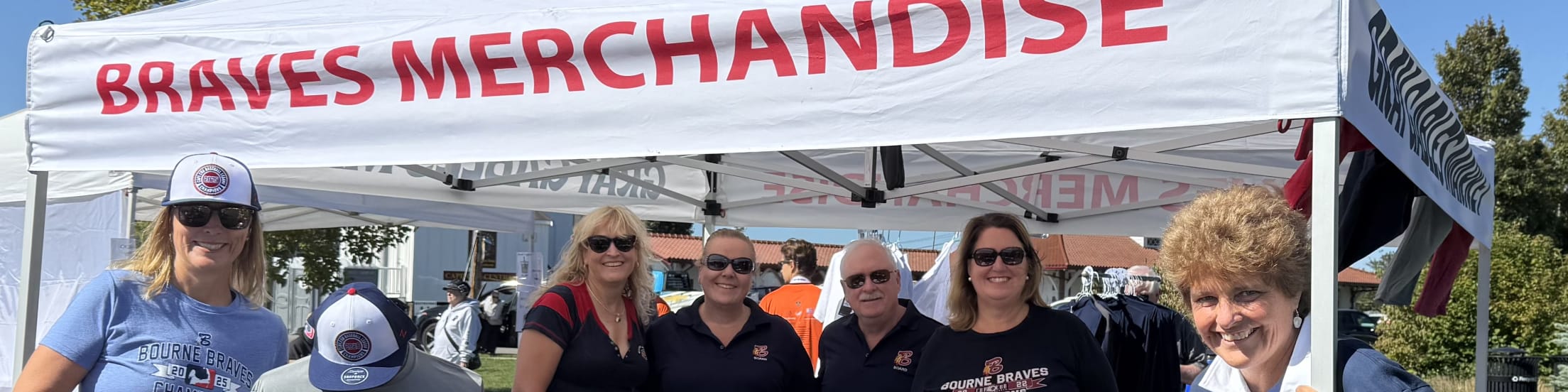 Bourne Braves staffers are all smiles at the Braves Merchandise tent.