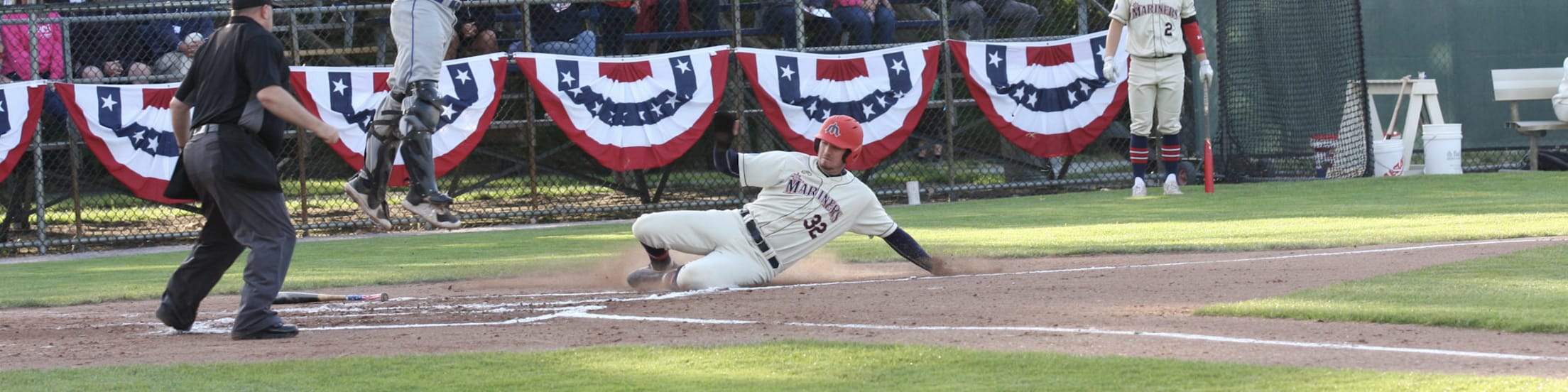 Mariners player slides home safely.