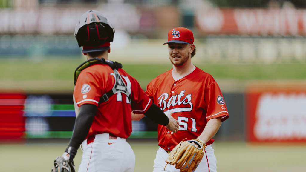Emilio Pagan gives Will Banfield a high-five after his six-pitch outing.