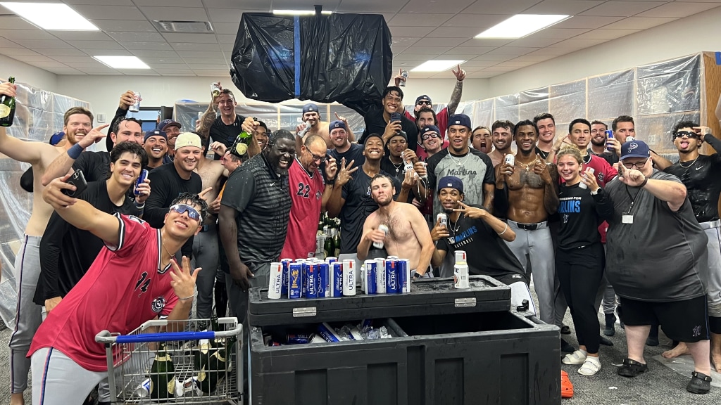 The Blue Wahoos enjoy their comeback win for playoff clincher Sunday inside the raucous visitors locker room in Columbus, Ga.