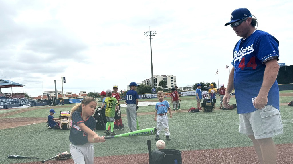 Former MLB player Phil Hiatt, part of Pensacola's former MLB players, watches a young participant make solid contact during the June 7 PlayBall Weekend Clinic at Blue Wahoos Stadium.