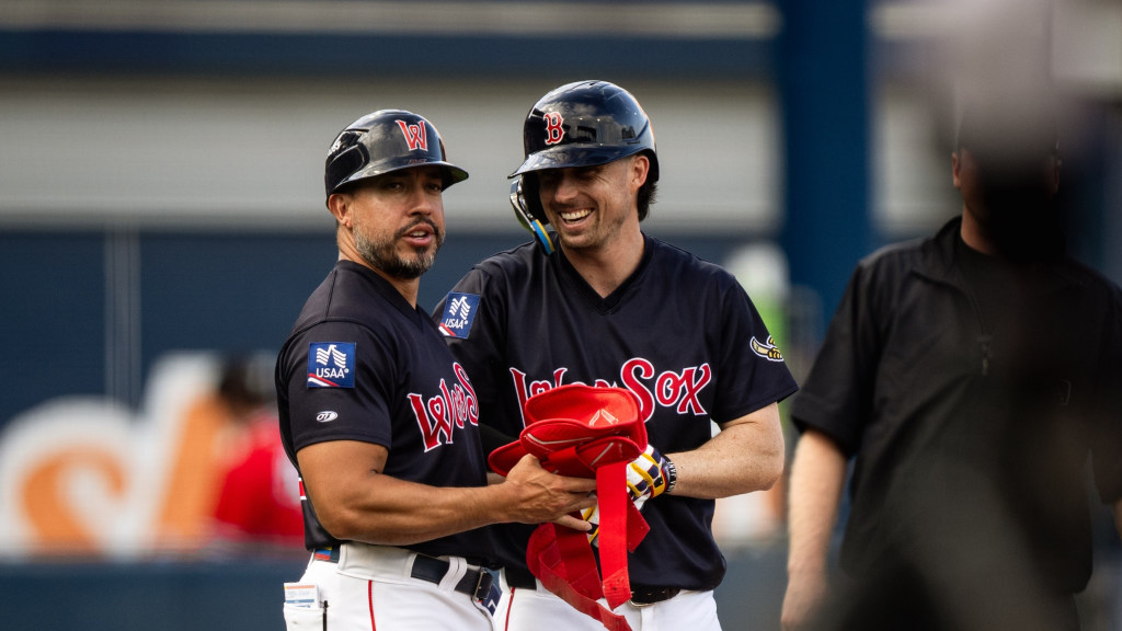 Nick Sogard, on rehab from the Red Sox, confers with WooSox manager Iggy Suarez after ripping an RBI triple in the 6<sup>th</sup> inning for the first WooSox hit of the game in Worcester’s 10-3 loss to the Rochester Red Wings on Saturday afternoon at Polar Park.