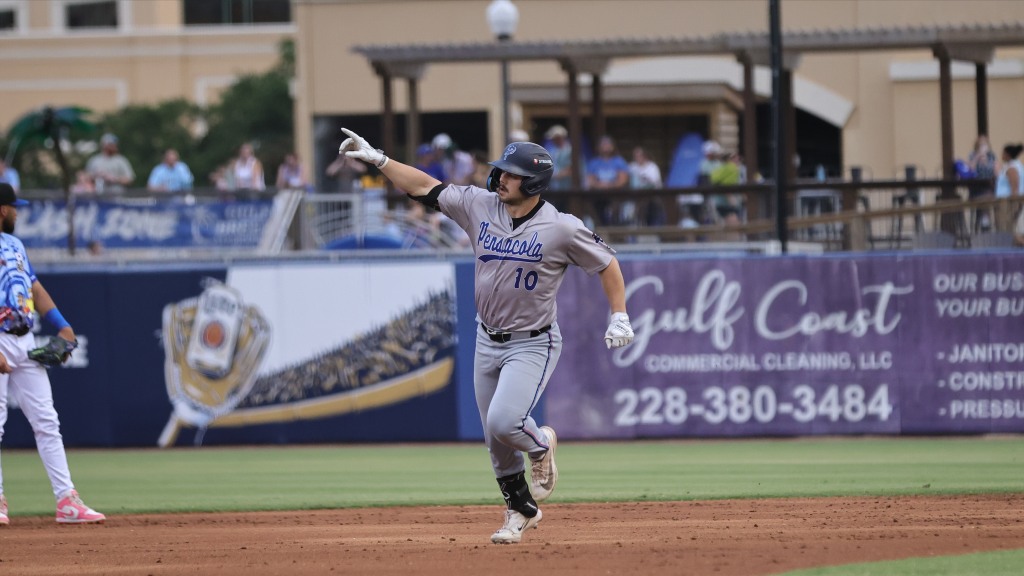 Brandon Compton points to his teammates after hitting a three-run homer in Sunday's Blue Wahoos win.