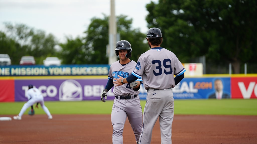 Trevor Austin, 3-for-5 with 2 runs scored, greets Jeremy Cologna in the 6-5 Hooks win Sunday at SA.