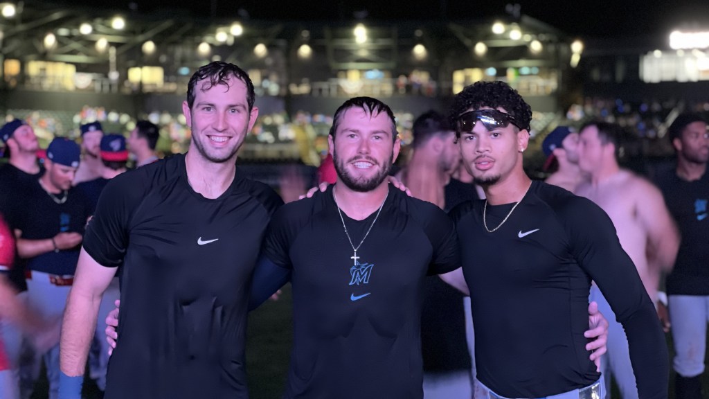 The Blue Wahoos three heroes of their dramatic win, left-to-right, Jay Beshears, Colby Shade and Cristian Hernandez, all of whom hit home runs in 9th inning, celebrate team's playoff clinching win in Columbus, Ga.