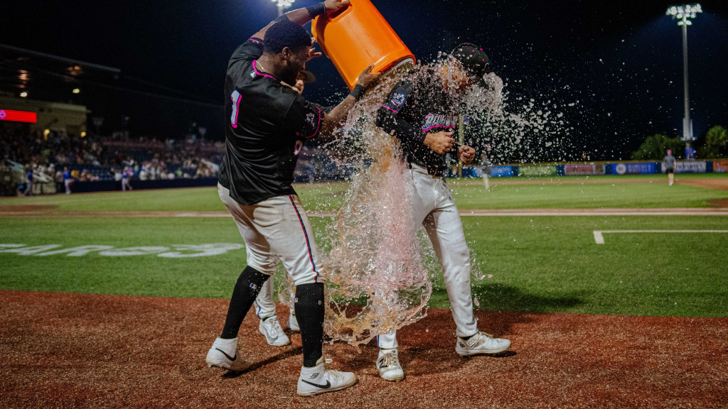 Outfielder Fenwick Trimble gets doused by teammates after being top star in Blue Wahoos; August 22 win against Knoxville at Blue Wahoos Stadium.