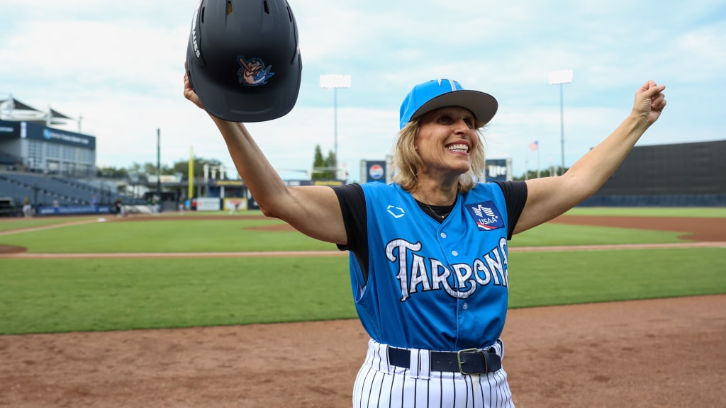 Carolyn, the Tarpons' honorary Bat Girl, motions to the crowd before Thursday's game.