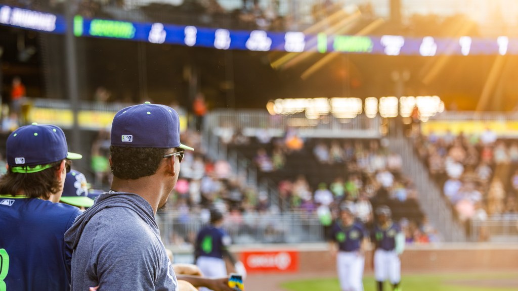 Spartanburgers dugout looks on.