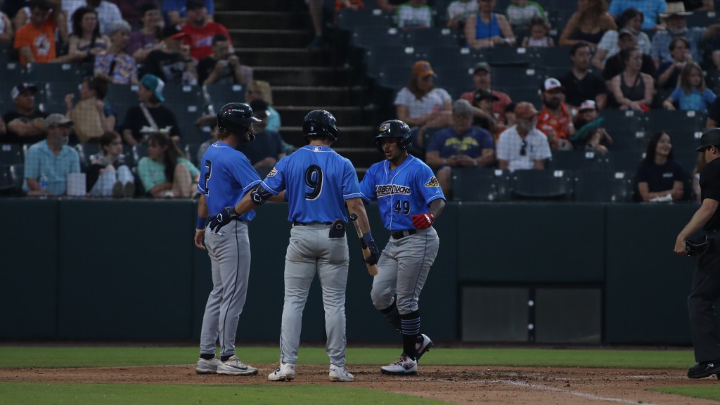 Kevin Rivas is greeted at home after hitting his first Double-A home run in Akron's June 6 win.