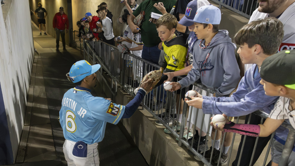 Naturals outfielder Rudy Martin Jr. signing autographs for fans after a recent win.