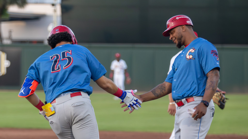 Phillies prospect Jaeden Calderon high-fives his first base coach after hitting a grand slam.