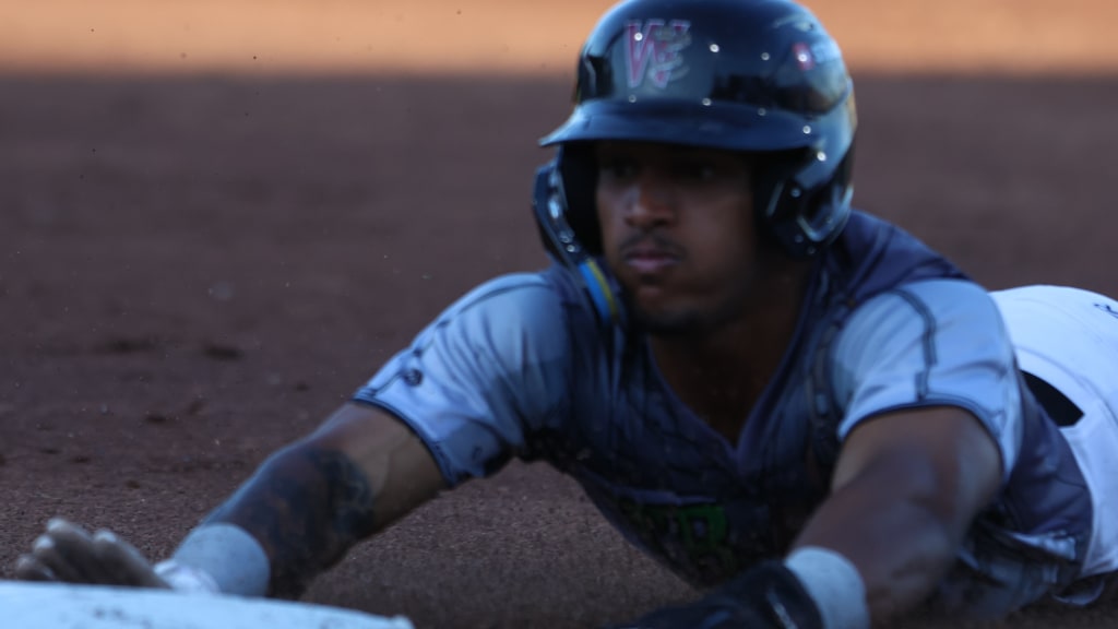 Josiah Ragsdale dives into third base in the third inning of Saturday's game at Neuroscience Group Field. Ragsdale was 3-for-4 with a stolen base for the Rattlers.