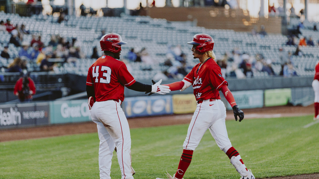 Edwin Arroyo and Hector Rodriguez share a high-five after an Arroyo home run.