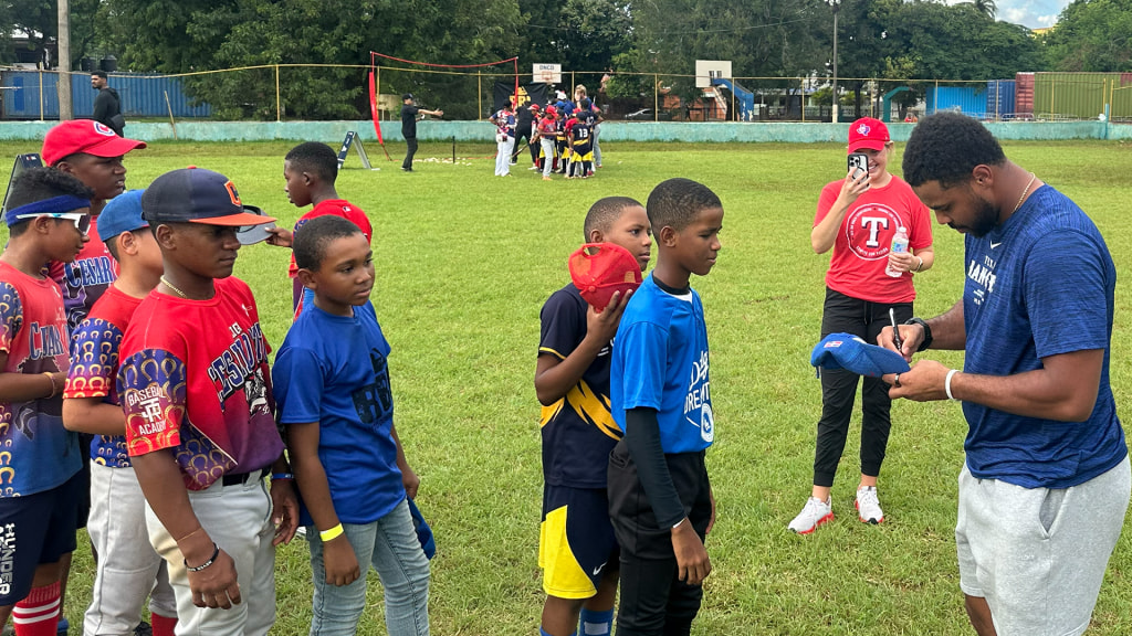 J'Briell Easley signs autographs for Dominican kids.