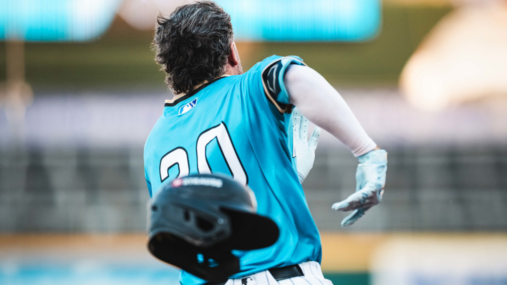 Jake Cave's helmet flies off as he rounds first base during his second inning double to deep centerfield.