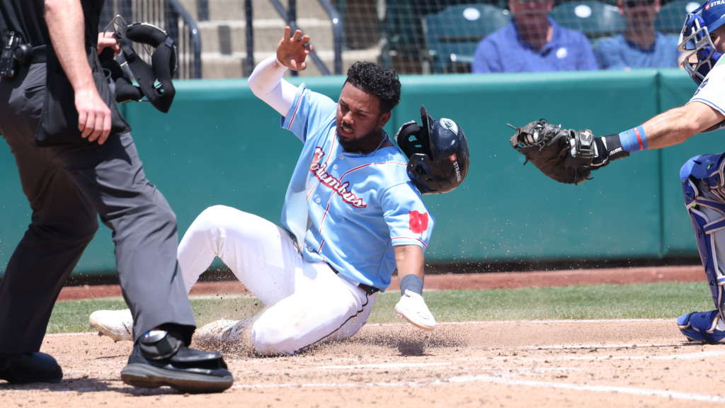 Dayan Frias is tagged out at home plate in the 6th inning Thursday