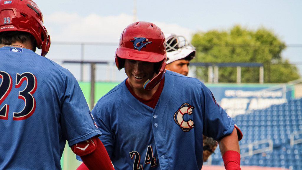 Phillies #11 prospect Griffin Burkholder celebrates a game-tying home run with his  Threshers teammates.