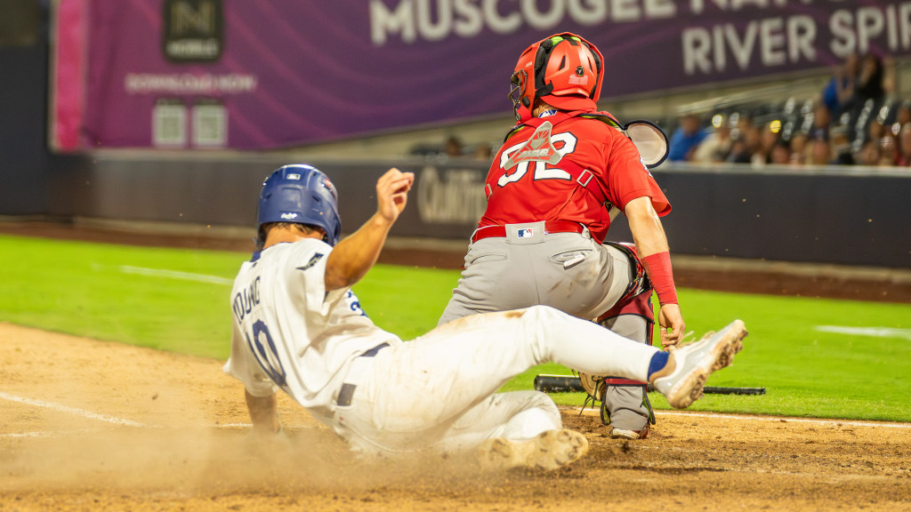Taylor Young slides home safely with Tulsa's third run in their Game 2, division series meeting with Springfield on Thursday night. The Cardinals rallied to defeat the Drillers and their record-breaking season.
