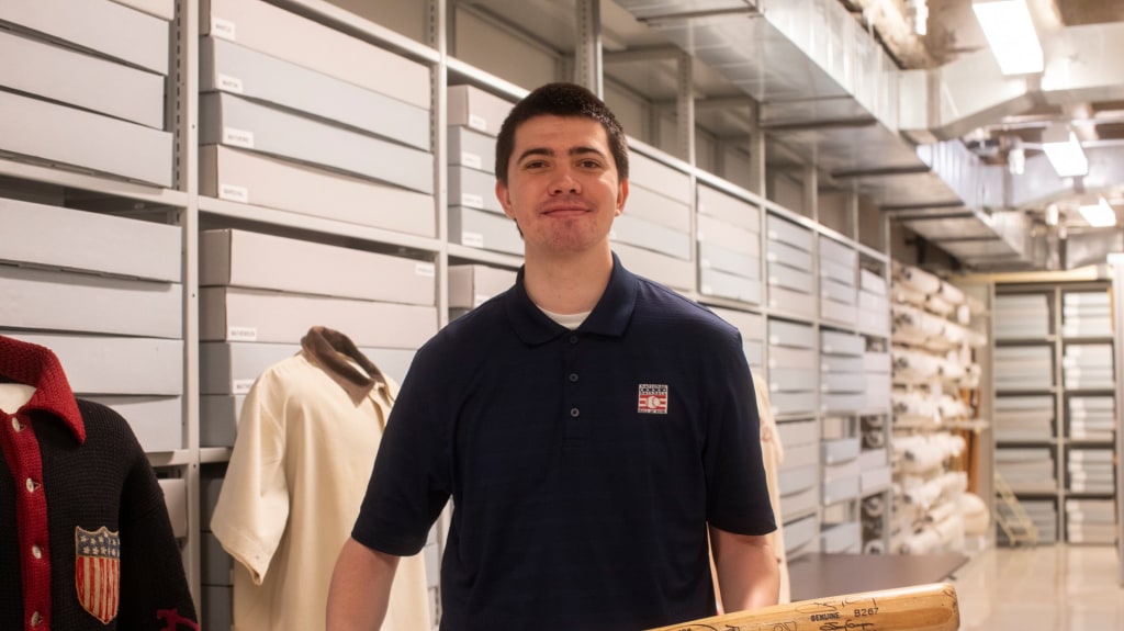 Former Pensacola Blue Wahoos social media specialist Kourage Kundahl, inside the artifacts warehouse at the National Baseball of Fame in Cooperstown, New York.