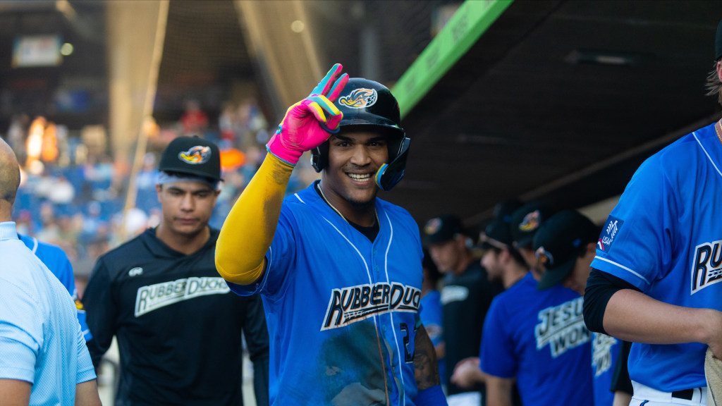 Alfonsin Rosario celebrates in the dugout after hitting a home run for the second day in a row.