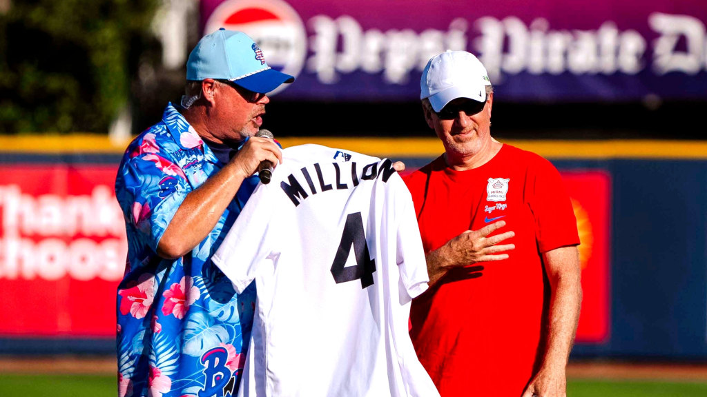David Stouffer, right, is presented a custom Blue Wahoos jersey to commemorate his selection as the 4-millionth fan at Blue Wahoos Stadium.