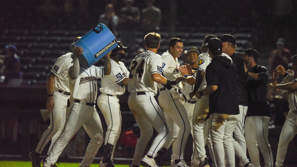 Dean Curley celebrates with the RubberDucks at home plate after his walk-off home run.