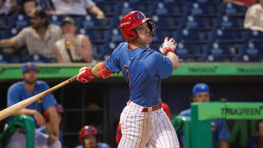 Phillies #28 prospect Matthew Ferrara smacks a base hit during a night game for the Clearwater Threshers.