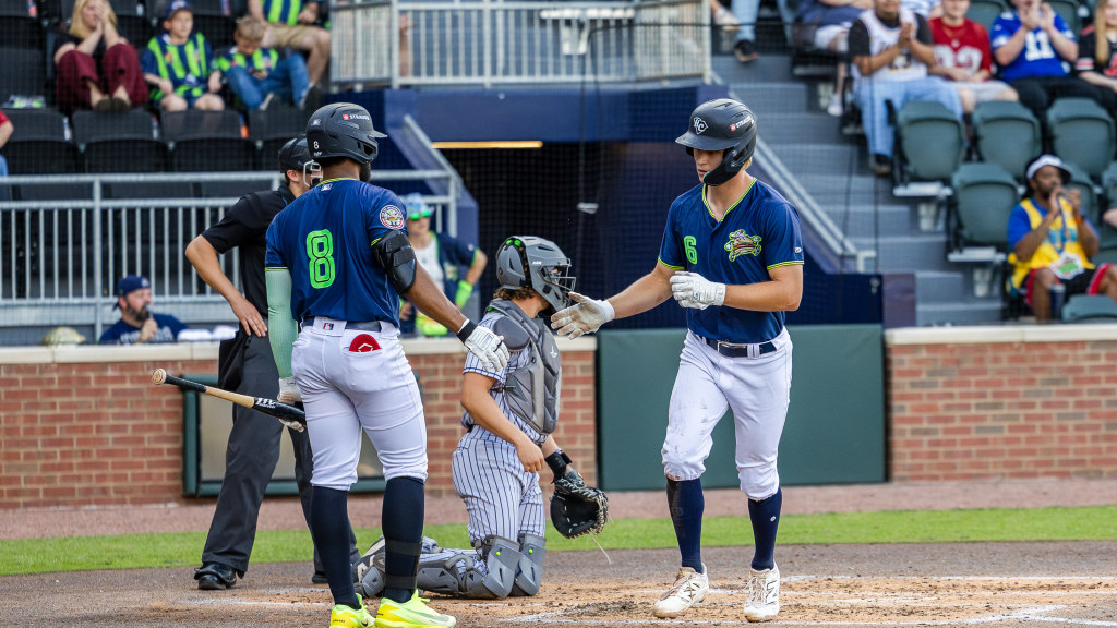 Luke Hanson celebrates scoring a run.