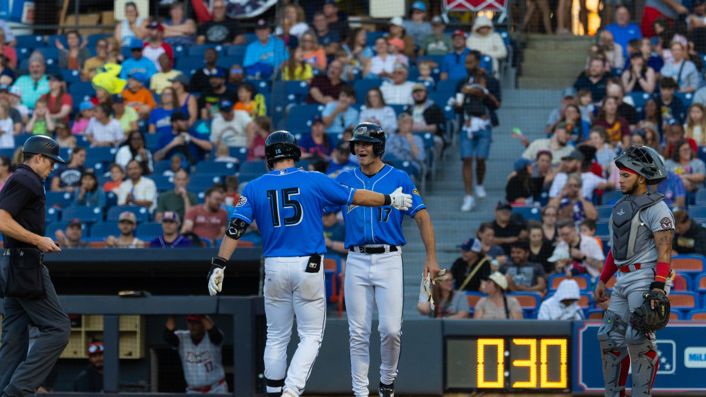 Aaron Walton and Jace LaViolette celebrate at home plate after Walton's two-run home run.