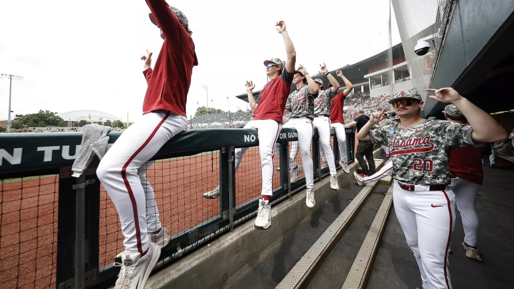Alabama Crimson Tide's dugout celebrates a run-scoring play during the Super Regional against St. John's that sent to Tide to the CWF for the first time in 17 years.